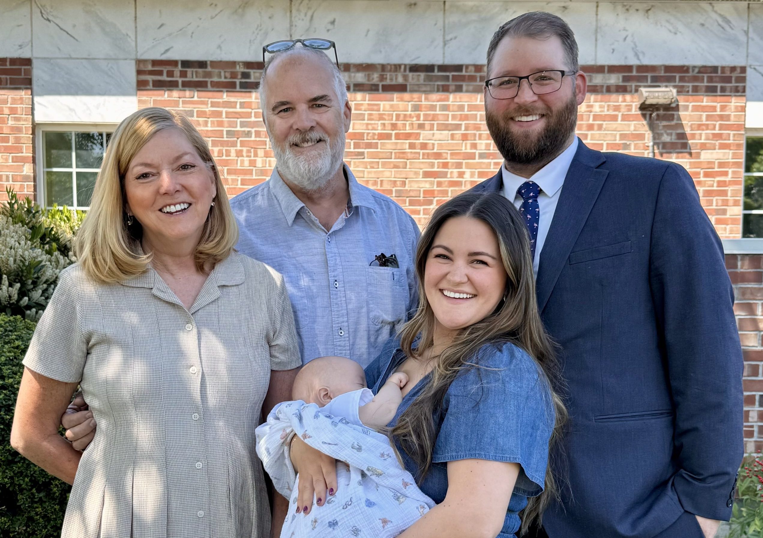 Smiling family grandparents, parents and baby